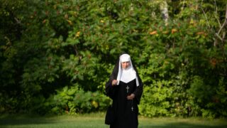 nun-walking-near-trees-2447958